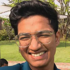 Gaurav smiling, in a teal blazer